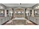 Spacious bathroom featuring a central tub, dual vanities, and tiled walls at 6475 Avalon Woods Dr, Lakeland, FL 33813