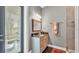Half bath with gray walls, granite counters, and access to the pool at 6475 Avalon Woods Dr, Lakeland, FL 33813