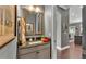 Bathroom vanity with granite counters and a neutral color scheme at 6475 Avalon Woods Dr, Lakeland, FL 33813