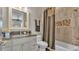 Bathroom featuring granite vanity, shower/tub combo, and mosaic tile accent at 6475 Avalon Woods Dr, Lakeland, FL 33813