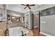 Bathroom with bathtub, vanity, walk-in shower, and ceiling fan at 6475 Avalon Woods Dr, Lakeland, FL 33813