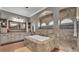 Bathroom with bathtub, vanity, walk-in shower, and mosaic tile accents at 6475 Avalon Woods Dr, Lakeland, FL 33813