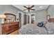 Comfortable bedroom with wood floors, dresser, and calming gray walls at 6475 Avalon Woods Dr, Lakeland, FL 33813