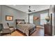 Spacious bedroom with hardwood floors, grey walls and plenty of natural light at 6475 Avalon Woods Dr, Lakeland, FL 33813