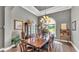 Traditional dining room with dark wood floors and large arched window overlooking the front yard at 6475 Avalon Woods Dr, Lakeland, FL 33813