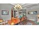 Traditional dining room with dark wood floors and views into the living spaces at 6475 Avalon Woods Dr, Lakeland, FL 33813