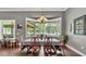Open dining room area with large windows overlooking the water, connecting to the outdoor space at 6475 Avalon Woods Dr, Lakeland, FL 33813