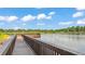 Gorgeous waterfront view with a wooden boardwalk and dock at 6475 Avalon Woods Dr, Lakeland, FL 33813