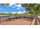 Serene lake view from a wooden dock with built-in benches, perfect for relaxing and enjoying the natural surroundings at 6475 Avalon Woods Dr, Lakeland, FL 33813