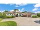 Stunning single-story home boasts a circular driveway and attached two-car garage at 6475 Avalon Woods Dr, Lakeland, FL 33813