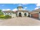 Beautiful home with tower detail, lovely front yard landscaping, and a brick driveway at 6475 Avalon Woods Dr, Lakeland, FL 33813