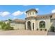 A home's unique turret entry, manicured landscaping, and paver driveway at 6475 Avalon Woods Dr, Lakeland, FL 33813