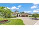 Stunning home with a turret entry, three-car garage, circular driveway, and manicured landscaping at 6475 Avalon Woods Dr, Lakeland, FL 33813