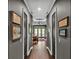 Hallway leading to main bedroom with hardwood floors and recessed lighting at 6475 Avalon Woods Dr, Lakeland, FL 33813