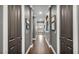 Hallway with hardwood flooring and grey colored walls leading to the main bathroom at 6475 Avalon Woods Dr, Lakeland, FL 33813