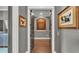 Hallway featuring hardwood floors and decorative art pieces at 6475 Avalon Woods Dr, Lakeland, FL 33813