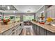 Kitchen featuring granite countertops, stainless steel appliances, and opens to the breakfast nook at 6475 Avalon Woods Dr, Lakeland, FL 33813