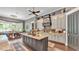 Open kitchen with granite countertops and large island with view to dining area at 6475 Avalon Woods Dr, Lakeland, FL 33813