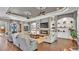 Open-concept living room with a stone fireplace and built-in shelving units at 6475 Avalon Woods Dr, Lakeland, FL 33813