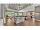 Spacious living area with hardwood floors, multiple seating areas, and a view of the lake at 6475 Avalon Woods Dr, Lakeland, FL 33813