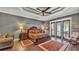 The main bedroom features hardwood floors, ceiling fan, and access to the back patio at 6475 Avalon Woods Dr, Lakeland, FL 33813