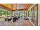 Covered patio with ceiling fan, outdoor dining, and seating area overlooking the pool at 6475 Avalon Woods Dr, Lakeland, FL 33813