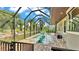 Screened-in pool area with brick pavers, lake views, and outdoor seating at 6475 Avalon Woods Dr, Lakeland, FL 33813