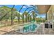 Screened-in pool area with lake views and outdoor seating at 6475 Avalon Woods Dr, Lakeland, FL 33813