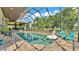 Screened-in pool with lake views, deck area, and outdoor seating; perfect for relaxing at 6475 Avalon Woods Dr, Lakeland, FL 33813