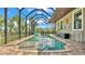Screened-in swimming pool with brick paver surround and a view of the lake at 6475 Avalon Woods Dr, Lakeland, FL 33813