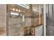Modern tiled shower with glass door, mosaic accent and neutral tones at 6475 Avalon Woods Dr, Lakeland, FL 33813