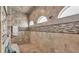 Tiled walk-in shower with overhead shower heads and bench seating at 6475 Avalon Woods Dr, Lakeland, FL 33813