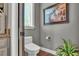 Elegant powder room with artwork, neutral colors, and a window at 6475 Avalon Woods Dr, Lakeland, FL 33813