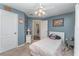 Bedroom with gray-blue walls, white trim, and ceiling fan at 6789 Ashbury Dr, Lakeland, FL 33809