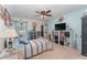 Nautical-themed bedroom featuring light blue walls, a ceiling fan, and coastal decor at 6789 Ashbury Dr, Lakeland, FL 33809