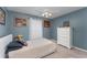 Simple bedroom with carpet, soft blue walls, and neutral furniture at 6789 Ashbury Dr, Lakeland, FL 33809
