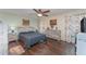 Bedroom with hardwood floors and a ceiling fan, features natural wood furniture at 6789 Ashbury Dr, Lakeland, FL 33809
