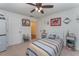 Bedroom with nautical decorations, ceiling fan, carpet and white trim at 6789 Ashbury Dr, Lakeland, FL 33809