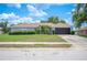 Charming single-story home with a well-maintained lawn, mature landscaping, and an attached two-car garage at 6789 Ashbury Dr, Lakeland, FL 33809