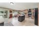 Bright kitchen with tile flooring, stainless steel appliances, and center island for dining at 6789 Ashbury Dr, Lakeland, FL 33809