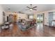 Spacious living room featuring wood floors, neutral walls, with large sliding doors leading to the lanai at 6789 Ashbury Dr, Lakeland, FL 33809
