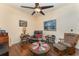 Cozy living room features hardwood floors, ceiling fan and comfortable seating arrangement at 6789 Ashbury Dr, Lakeland, FL 33809