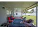 Covered patio with comfortable seating and a view of the well-maintained backyard at 6789 Ashbury Dr, Lakeland, FL 33809
