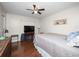 Comfortable bedroom with wood floors, a ceiling fan, and natural light at 803 Orchid Springs Dr, Winter Haven, FL 33884