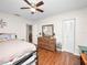 Bedroom with wooden dresser, closet, and hardwood floors at 803 Orchid Springs Dr, Winter Haven, FL 33884
