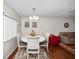 Dining room featuring white table and chairs, wood floors, and view into living room at 803 Orchid Springs Dr, Winter Haven, FL 33884