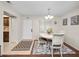 Bright dining room with a white table, chairs, and natural light at 803 Orchid Springs Dr, Winter Haven, FL 33884