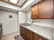 Functional kitchen with granite countertops, stainless sink, and wood cabinetry at 803 Orchid Springs Dr, Winter Haven, FL 33884