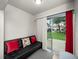 Cozy space with a futon and sliding glass door leading to a green area at 803 Orchid Springs Dr, Winter Haven, FL 33884