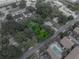 Aerial view of a property surrounded by trees near a community pool at 829 N Lake Ave, Lakeland, FL 33801